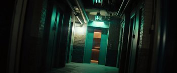 Movie still from “Nightbooks” (2021), directed by David Yarovesky – An elevator in a dark room with lights on the side of it; Extreme Wide shot, Low angle