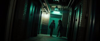 Movie still from “Nightbooks” (2021), directed by David Yarovesky – A couple of people standing next to each other in a room; Wide shot, Low angle