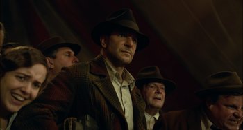 Movie still from “Nightmare Alley” (2021), directed by Guillermo del Toro – A group of men wearing hats and suits; Medium shot, Low angle