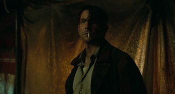 Movie still from “Nightmare Alley” (2021), directed by Guillermo del Toro – A man with a cigarette in his mouth; Close Up shot, Low angle