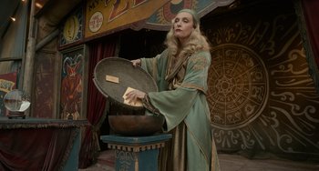 Movie still from “Nightmare Alley” (2021), directed by Guillermo del Toro – A woman in a green robe holding a bowl; Medium shot, Low angle