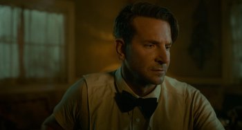 Movie still from “Nightmare Alley” (2021), directed by Guillermo del Toro – A person wearing a shirt and a bow tie; Close Up shot, Over the shoulder angle