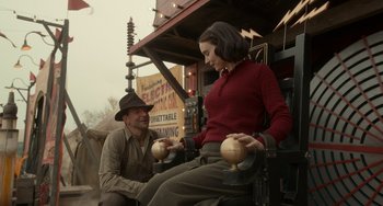 Movie still from “Nightmare Alley” (2021), directed by Guillermo del Toro – A man and a woman sitting next to each other; Medium shot, Low angle