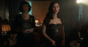 Movie still from “Nightmare Alley” (2021), directed by Guillermo del Toro – Two women standing next to each other in a room; Medium shot, Low angle