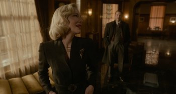 Movie still from “Nightmare Alley” (2021), directed by Guillermo del Toro – A man and a woman standing in front of a window; Medium shot, Over the shoulder angle