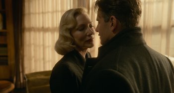 Movie still from “Nightmare Alley” (2021), directed by Guillermo del Toro – A man and a woman standing next to each other; Close Up shot, Low angle