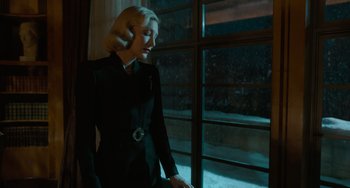 Movie still from “Nightmare Alley” (2021), directed by Guillermo del Toro – A woman standing in front of a large window; Medium shot, Low angle
