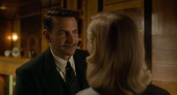 Movie still from “Nightmare Alley” (2021), directed by Guillermo del Toro – A man in a suit and tie looking at a woman in a dress; Close Up shot, Over the shoulder angle