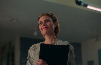 Movie still from “Nitram” (2021), directed by Justin Kurzel – A woman holding a clipboard in her hands; Close Up shot, Low angle