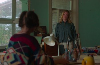 Movie still from “Nitram” (2021), directed by Justin Kurzel – A man standing in front of a mirror in a room; Medium shot, Over the shoulder angle