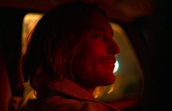 Movie still from “Nitram” (2021), directed by Justin Kurzel – A person with long hair; Close Up shot, Low angle