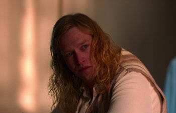 Movie still from “Nitram” (2021), directed by Justin Kurzel – A person with long red hair; Close Up shot, Over the shoulder angle