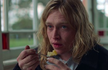 Movie still from “Nitram” (2021), directed by Justin Kurzel – A woman eating food while holding a spoon; Close Up shot, High angle