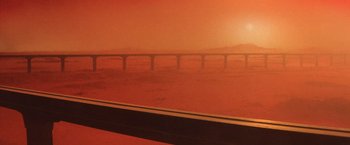 Movie still from “No Escape” (1994), directed by Martin Campbell – A view of a bridge in the distance from a train window; Extreme Wide shot, Low angle