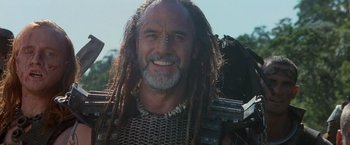 Movie still from “No Escape” (1994), directed by Martin Campbell – A person with dreadlocks; Close Up shot, Low angle