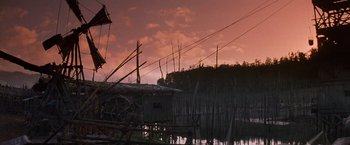 Movie still from “No Escape” (1994), directed by Martin Campbell – A dock with a bunch of poles in the water; Extreme Wide shot, Low angle