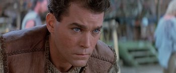 Movie still from “No Escape” (1994), directed by Martin Campbell – A man's face with blue eyes; Close Up shot, Over the shoulder angle
