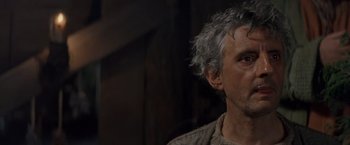 Movie still from “No Escape” (1994), directed by Martin Campbell – An older man with grey hair looking to his left; Close Up shot, Low angle