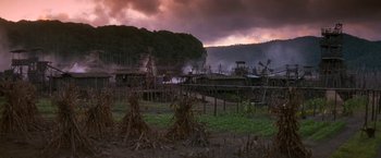 Movie still from “No Escape” (1994), directed by Martin Campbell – A field that has a lot of trees in it; Extreme Wide shot, High angle