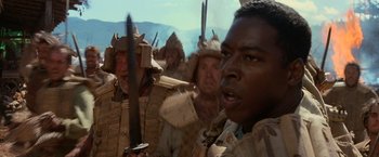 Movie still from “No Escape” (1994), directed by Martin Campbell – A group of men in samurai garb holding swords; Close Up shot, Low angle