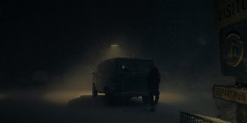 Movie still from “No Exit” (2022), directed by Damien Power – A van parked in the dark in the snow; Extreme Wide shot, Low angle