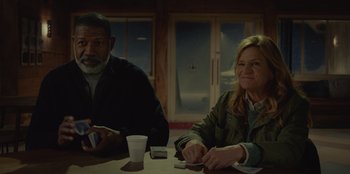 Movie still from “No Exit” (2022), directed by Damien Power – A man and a woman sitting at a table; Medium shot, Low angle