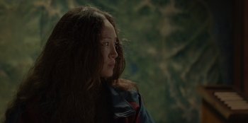 Movie still from “No Exit” (2022), directed by Damien Power – A woman with long brown hair looking to her left; Close Up shot, Low angle