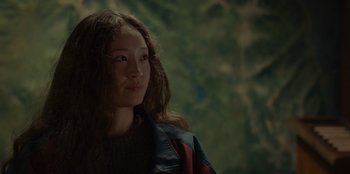 Movie still from “No Exit” (2022), directed by Damien Power – A woman with long brown hair looking to her left; Close Up shot, Over the shoulder angle