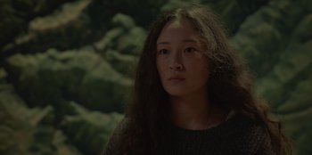 Movie still from “No Exit” (2022), directed by Damien Power – A woman with long black hair is looking at the camera; Close Up shot, Low angle