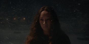 Movie still from “No Exit” (2022), directed by Damien Power – A woman with long brown hair standing in front of a window; Close Up shot, Low angle