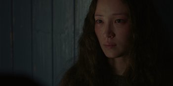 Movie still from “No Exit” (2022), directed by Damien Power – A woman with long brown hair is crying; Close Up shot, Low angle