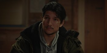 Movie still from “No Exit” (2022), directed by Damien Power – A person wearing a jacket and looking at the camera; Close Up shot, Over the shoulder angle