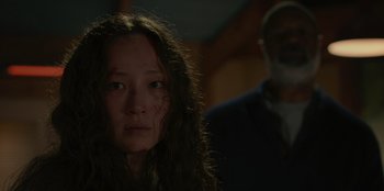 Movie still from “No Exit” (2022), directed by Damien Power – A woman with long hair and a man in a dark room; Close Up shot, Over the shoulder angle