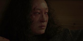 Movie still from “No Exit” (2022), directed by Damien Power – A person's face covered in blood; Close Up shot, Low angle