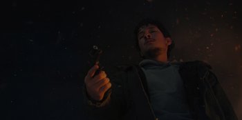Movie still from “No Exit” (2022), directed by Damien Power – A man holding a gun in the dark; Close Up shot, Low angle