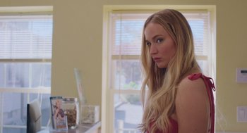 Movie still from “No Hard Feelings” (2023), directed by Gene Stupnitsky – A beautiful young lady standing in front of a window; Close Up shot, Over the shoulder angle