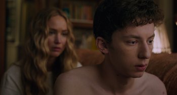 Movie still from “No Hard Feelings” (2023), directed by Gene Stupnitsky – A man and a woman sitting next to each other in a room; Close Up shot, Over the shoulder angle