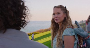 Movie still from “No Hard Feelings” (2023), directed by Gene Stupnitsky – A woman with long blonde hair standing next to a man; Close Up shot, Over the shoulder angle