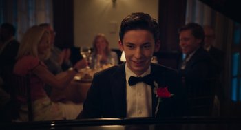 Movie still from “No Hard Feelings” (2023), directed by Gene Stupnitsky – A young man in a tuxedo is playing the piano; Close Up shot, Over the shoulder angle