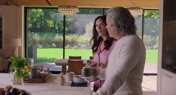 Movie still from “No Hard Feelings” (2023), directed by Gene Stupnitsky – Two women standing in front of a dining room table; Medium shot, Over the shoulder angle