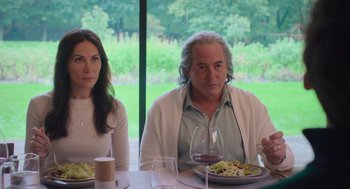 Movie still from “No Hard Feelings” (2023), directed by Gene Stupnitsky – A man and a woman sitting at a table with plates of food on it; Medium shot, Over the shoulder angle