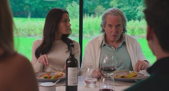 Movie still from “No Hard Feelings” (2023), directed by Gene Stupnitsky – A man and a woman sitting at a dinner table; Medium shot, Over the shoulder angle