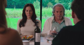 Movie still from “No Hard Feelings” (2023), directed by Gene Stupnitsky – A man and a woman sitting at a dinner table; Medium shot, Over the shoulder angle