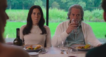 Movie still from “No Hard Feelings” (2023), directed by Gene Stupnitsky – A man and a woman sitting at a dinner table drinking wine; Medium shot, Over the shoulder angle
