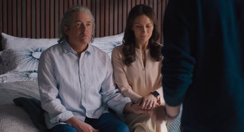 Movie still from “No Hard Feelings” (2023), directed by Gene Stupnitsky – A man and a woman sitting next to each other on a couch; Medium shot, Over the shoulder angle