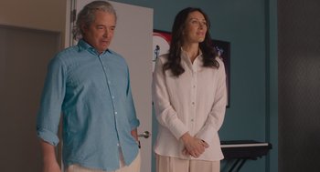 Movie still from “No Hard Feelings” (2023), directed by Gene Stupnitsky – A man and a woman standing next to each other in a room; Medium shot, Over the shoulder angle