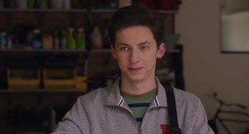 Movie still from “No Hard Feelings” (2023), directed by Gene Stupnitsky – A young man is posing for a picture; Close Up shot, Low angle