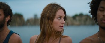 Movie still from “No Limit” (2022), directed by David M. Rosenthal – A person with long brown hair; Close Up shot, Low angle