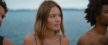 Movie still from “No Limit” (2022), directed by David M. Rosenthal – A beautiful woman with long brown hair standing next to the ocean; Close Up shot, Low angle