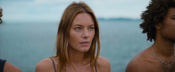 Movie still from “No Limit” (2022), directed by David M. Rosenthal – A beautiful woman with long brown hair looking at the camera; Close Up shot, Low angle